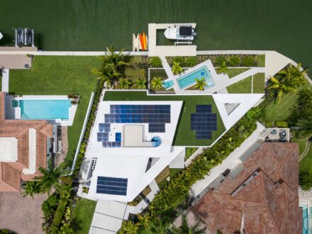 overhead drone image of unique architectural Bird Key home with solar panels on Sarasota Bay