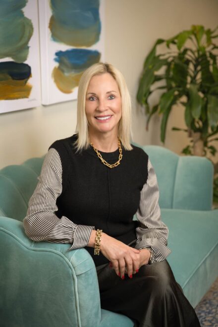 Profession business portrait of a woman sitting on a couch in an office environment